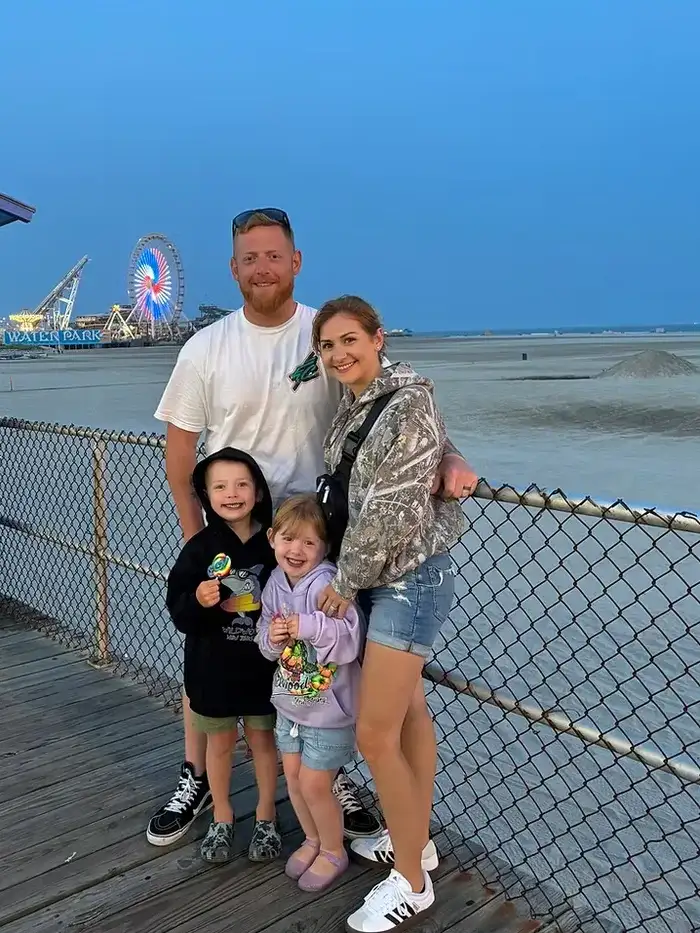 Kris Funk, owner of Funk Landscape & Design, with his wife and two children