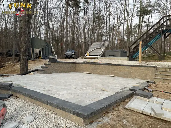 Patio base with border in place below the home's deck stairs