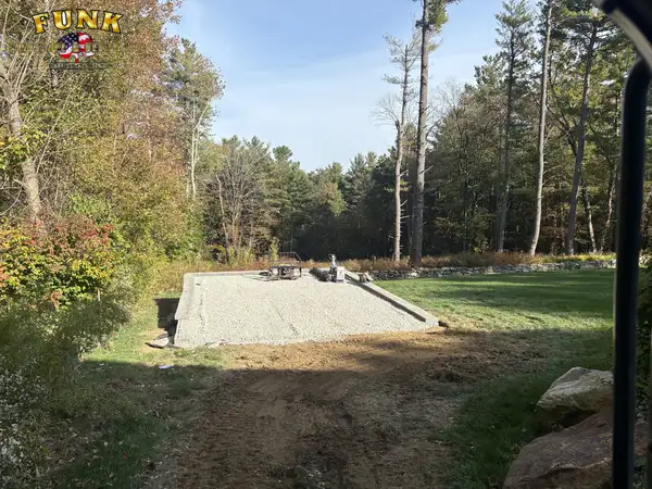 Compacted gravel base pad prepared for patio installation