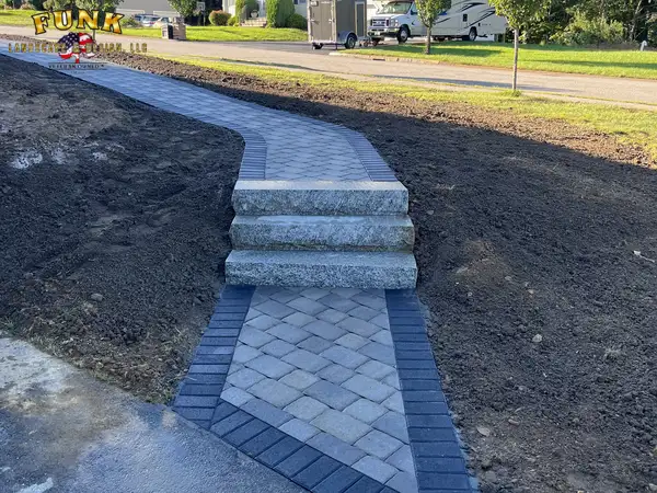 Paver walkway with granite steps set into the slope
