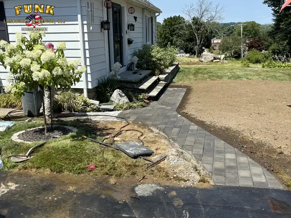 Walkway edge and planting bed beside the front porch