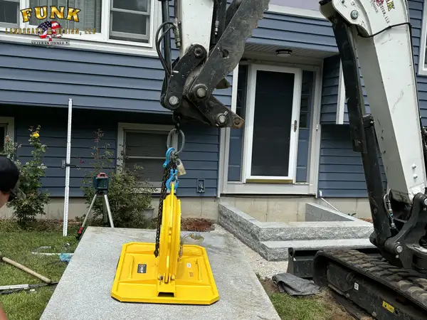 Excavator preparing the walkway base along the front of the house
