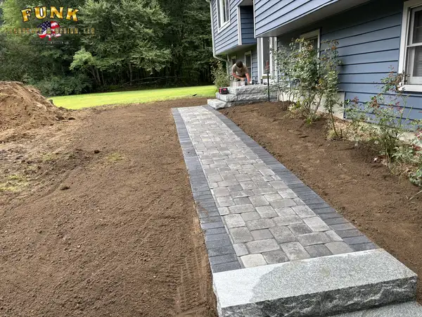 Walkway border pavers set with soil graded on both sides