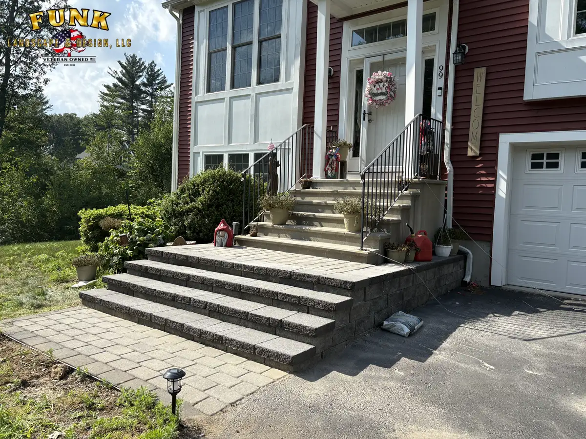 Finished stone front steps with paver landing at the entry