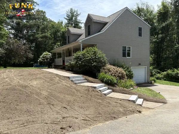 Granite steps climbing a front slope, set by Funk Landscape & Design