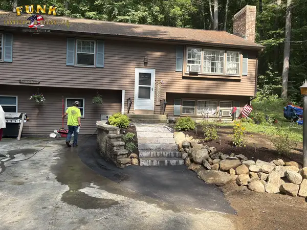Rebuilt front steps and stone retaining wall at the driveway