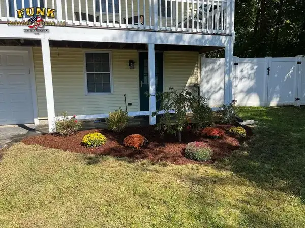 Flower bed installation in Charlton, MA by Funk Landscape & Design